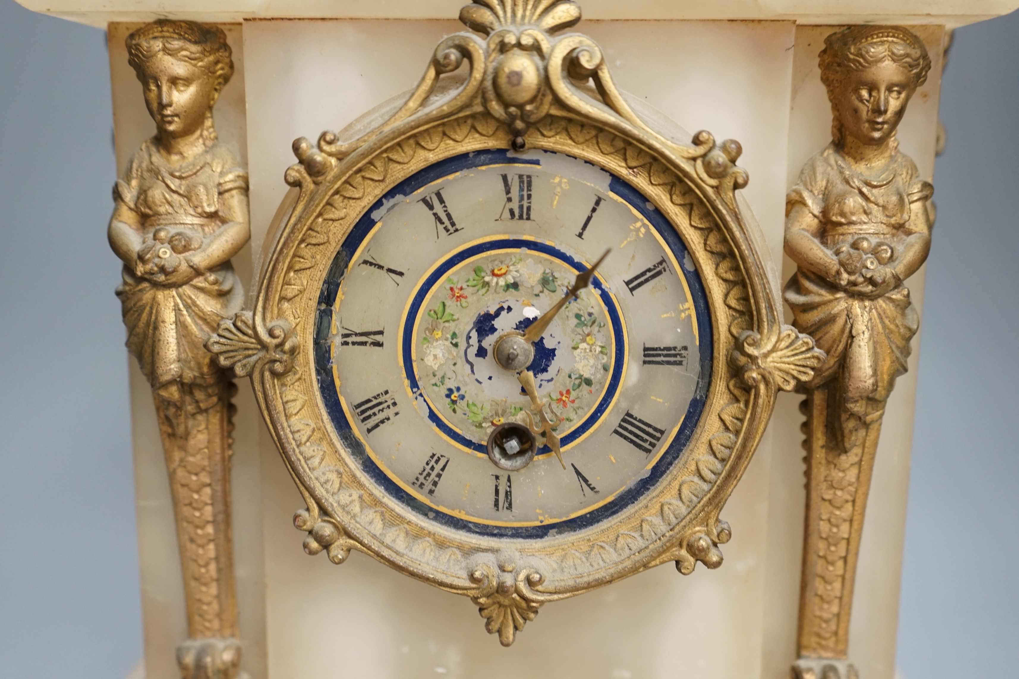 A French alabaster gilt mounted mantel clock, 44cms high